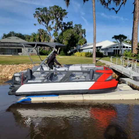A boat is sitting on top of a dock in the water.
